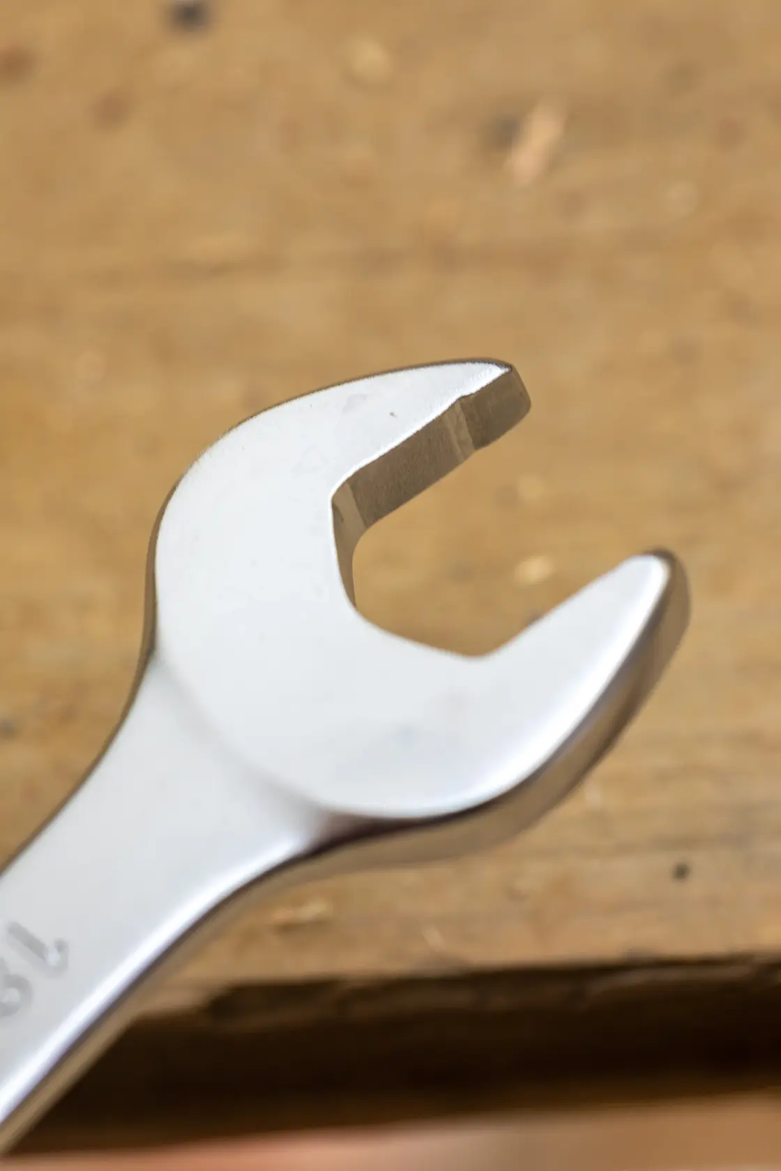 STANLEY FMMT13070-0 open-end wrench close-up, silver finish, on wooden surface.