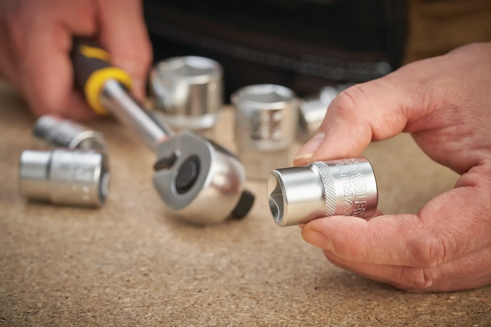 STANLEY FMMT17231-0 photography of chrome socket with ratchet on work surface, close-up view.