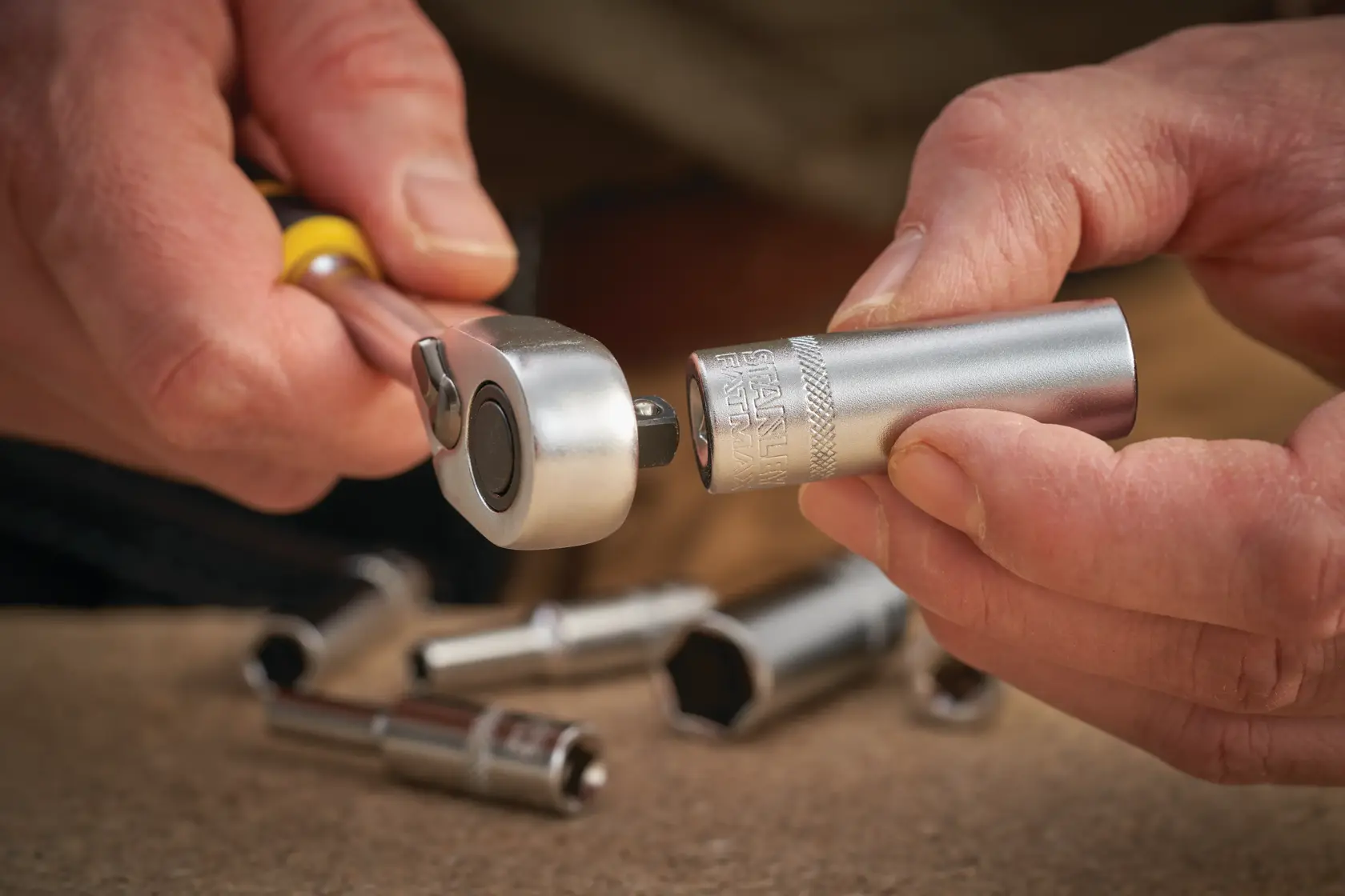 STANLEY FMMT17965-0 socket being attached to ratchet handle, close-up photography, socket set visible.