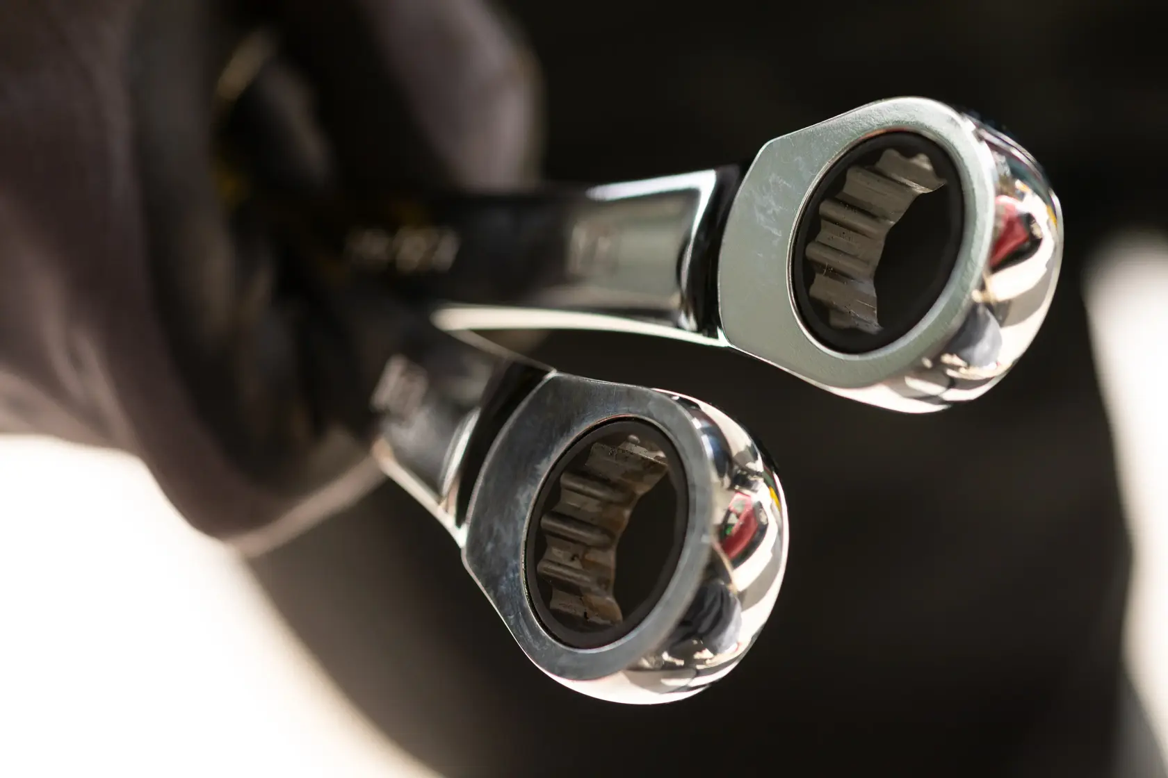 STANLEY STMT89916-0 ratcheting wrenches close-up, photography, chrome finish, held in a gloved hand.